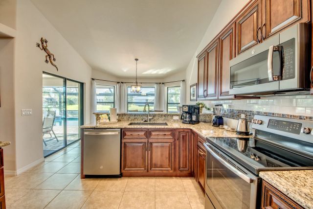 Kitchen with wooden cabinets, granite countertops and stainless-steel appliances