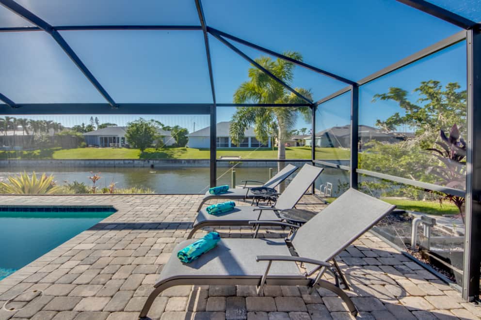 Sun loungers on the pool terrace overlooking the canal