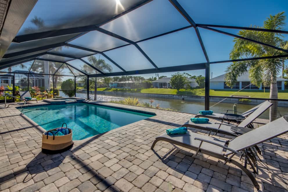 Screened pool terrace with views across the canal