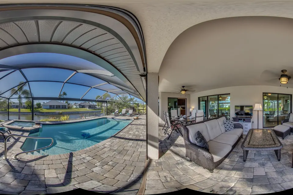 360° view of the covered lanai with seating, the pool and the spa