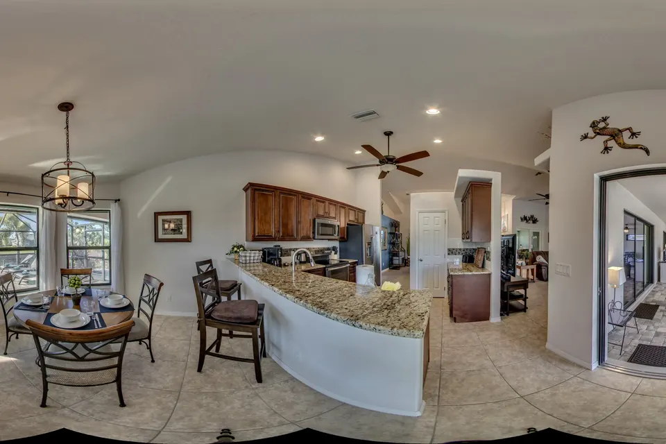 360° view of the kitchen with its counter and the nook with a round table